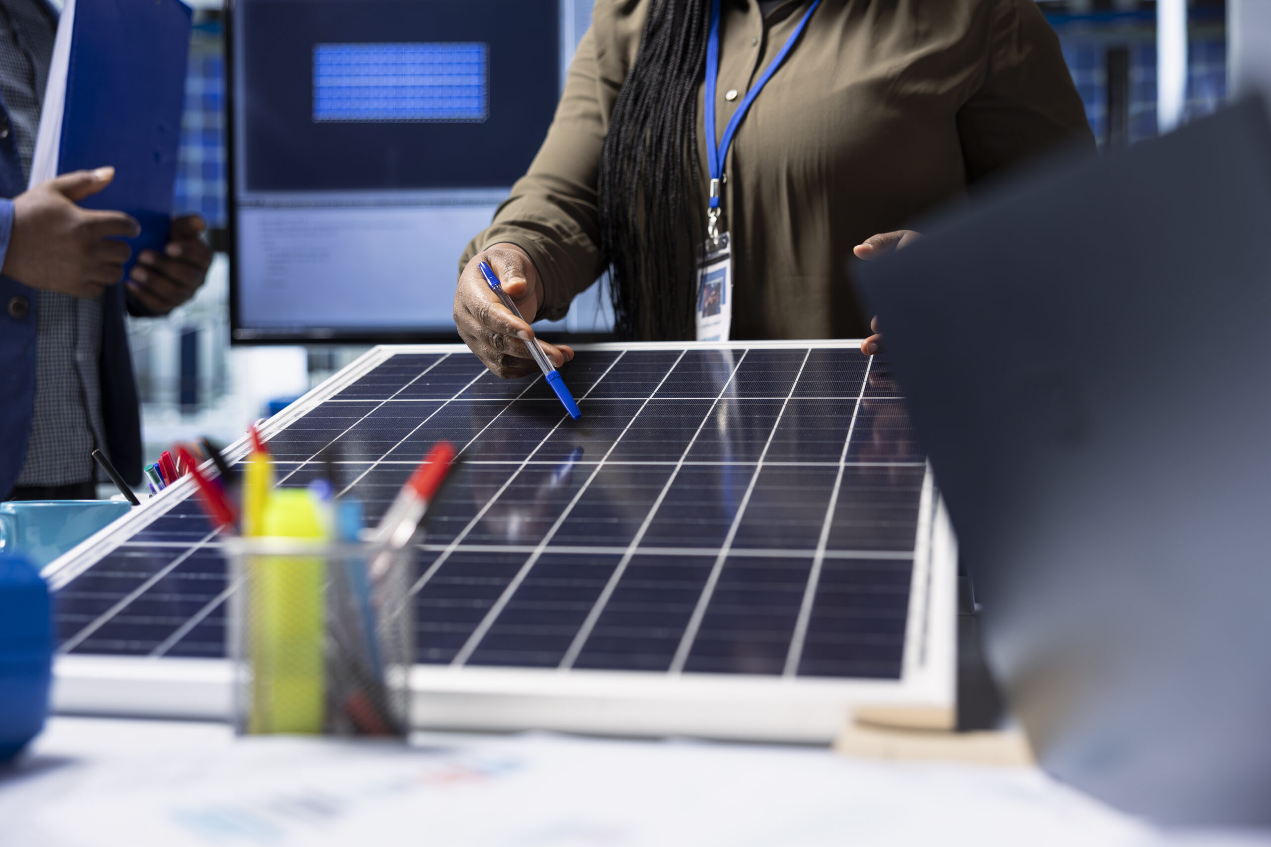 shareholders meet with industrial plant manager to review solar panel components